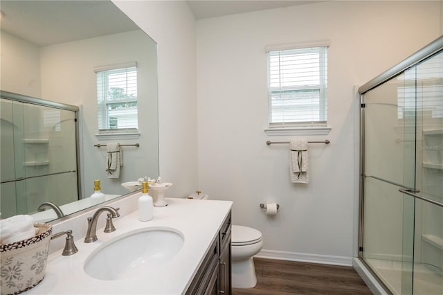 bathroom featuring walk in shower, wood-type flooring, toilet, and vanity