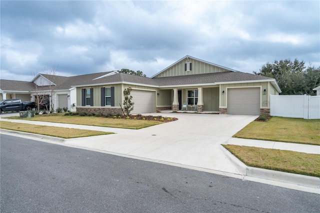 view of front of home with a garage and a front lawn