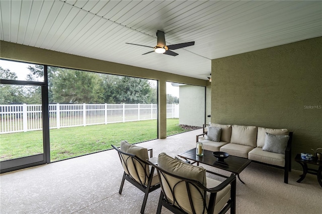 sunroom / solarium featuring ceiling fan