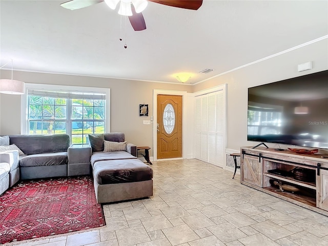 living room with ceiling fan and ornamental molding