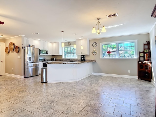 kitchen featuring kitchen peninsula, white cabinets, stainless steel appliances, and hanging light fixtures