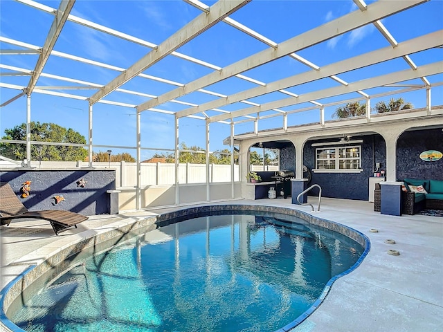 view of swimming pool featuring glass enclosure, ceiling fan, and a patio area