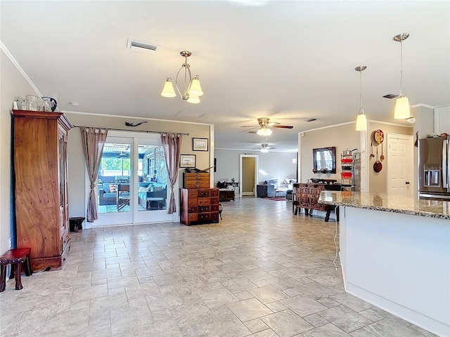 interior space featuring ornamental molding, decorative light fixtures, stainless steel fridge with ice dispenser, and light stone countertops