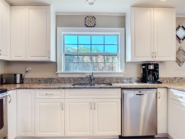 kitchen with sink, dark stone countertops, white cabinets, and dishwasher