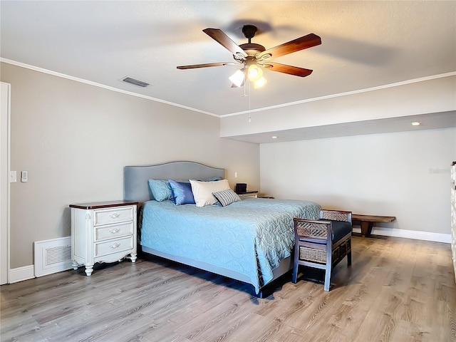 bedroom featuring crown molding, ceiling fan, and light hardwood / wood-style flooring