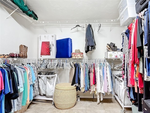 walk in closet with tile patterned floors