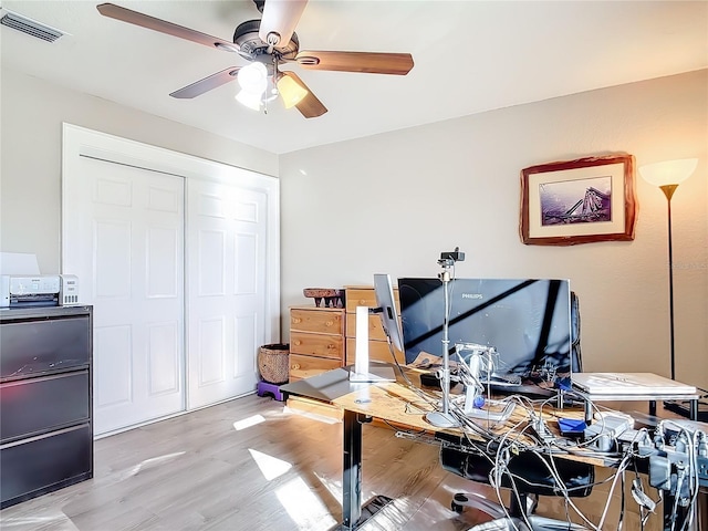 office area with light hardwood / wood-style floors and ceiling fan