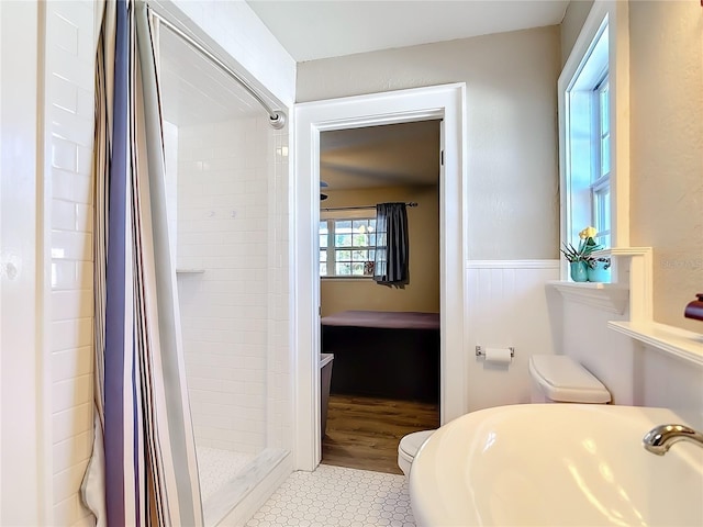 bathroom with curtained shower and toilet