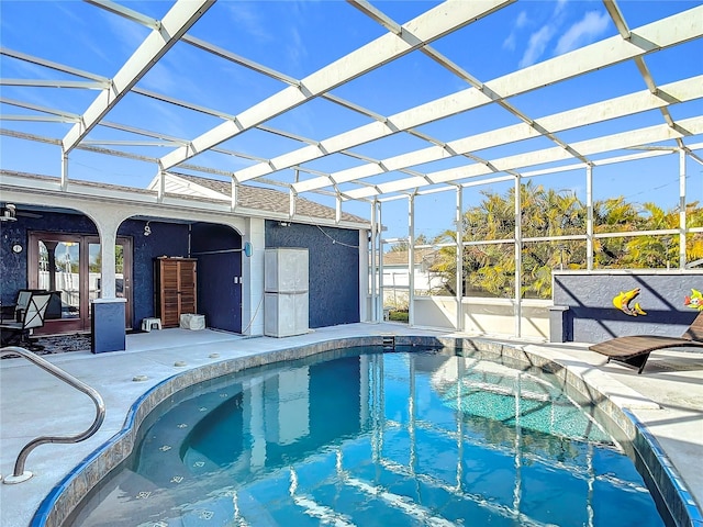 view of pool featuring a patio, french doors, and a lanai