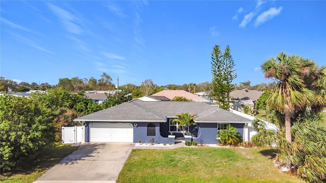 ranch-style house with a front yard and a garage