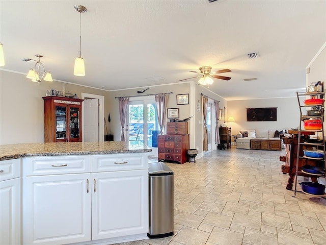 2457 Tamworth Ter, Punta Gorda, FL 33983 - kitchen featuring ceiling fan, white cabinetry, open floor plan, crown molding, and decorative light fixtures