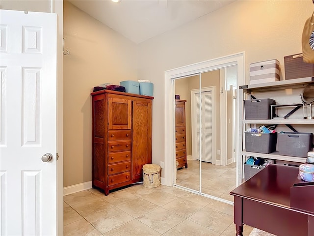 2457 Tamworth Ter, Punta Gorda, FL 33983 - bedroom with light tile patterned flooring, a closet, baseboards, and vaulted ceiling
