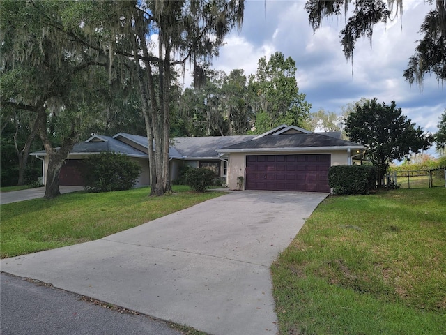 ranch-style house with a garage, driveway, a front lawn, and fence