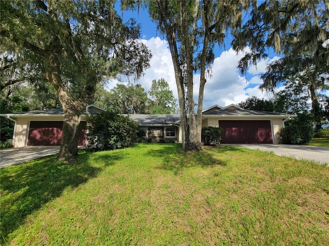 ranch-style home featuring a front yard, an attached garage, driveway, and stucco siding