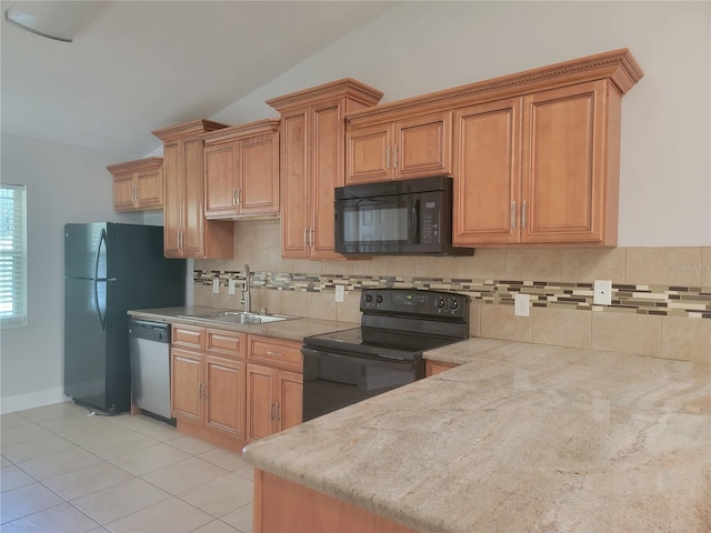 kitchen featuring black appliances, a sink, tasteful backsplash, light tile patterned flooring, and lofted ceiling