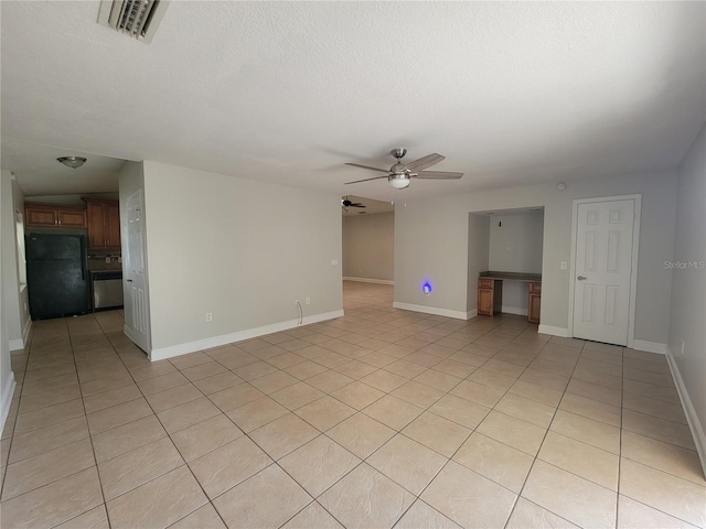 unfurnished living room with baseboards, a textured ceiling, ceiling fan, and light tile patterned flooring