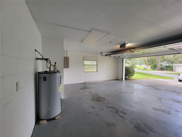 garage with water heater, concrete block wall, a garage door opener, and electric panel