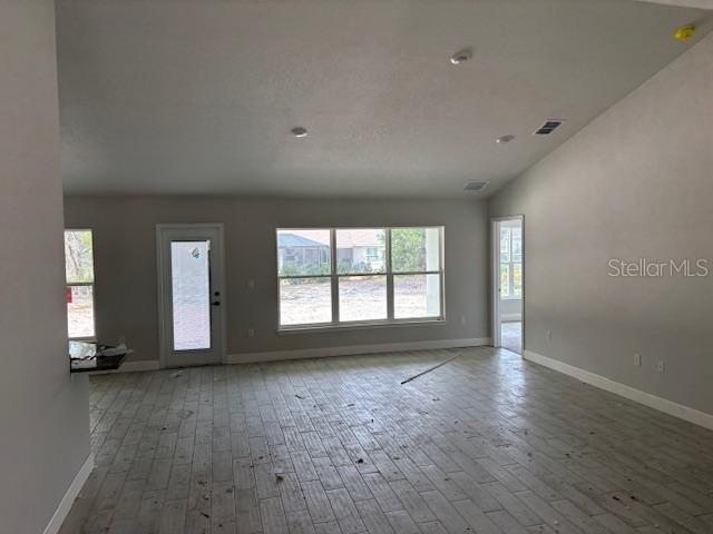 unfurnished living room featuring hardwood / wood-style flooring