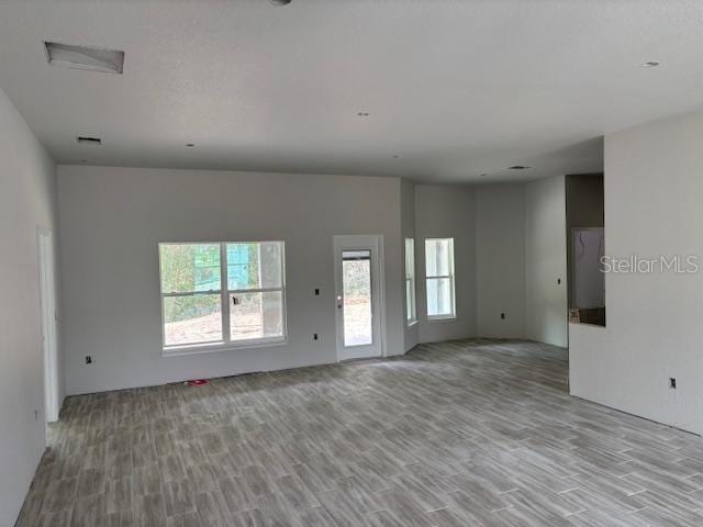 unfurnished room with light wood-type flooring