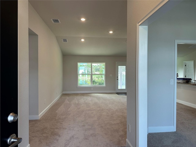 spare room with light colored carpet