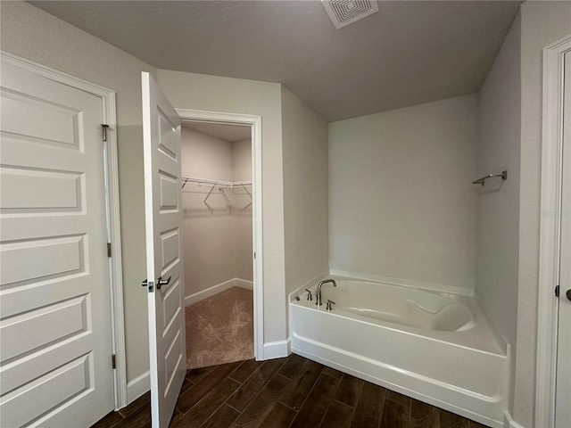 bathroom with a tub to relax in