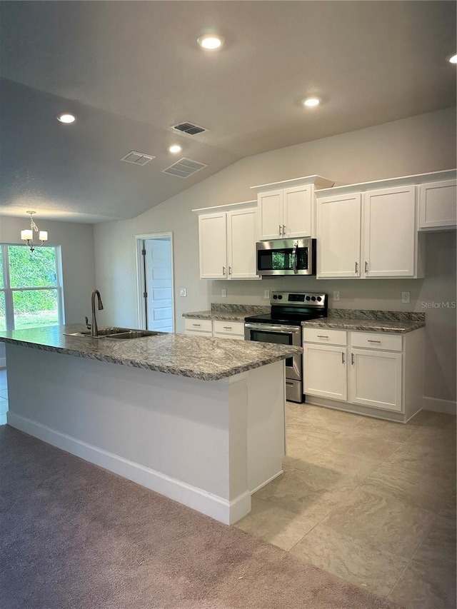 kitchen with white cabinetry, appliances with stainless steel finishes, sink, and a center island with sink