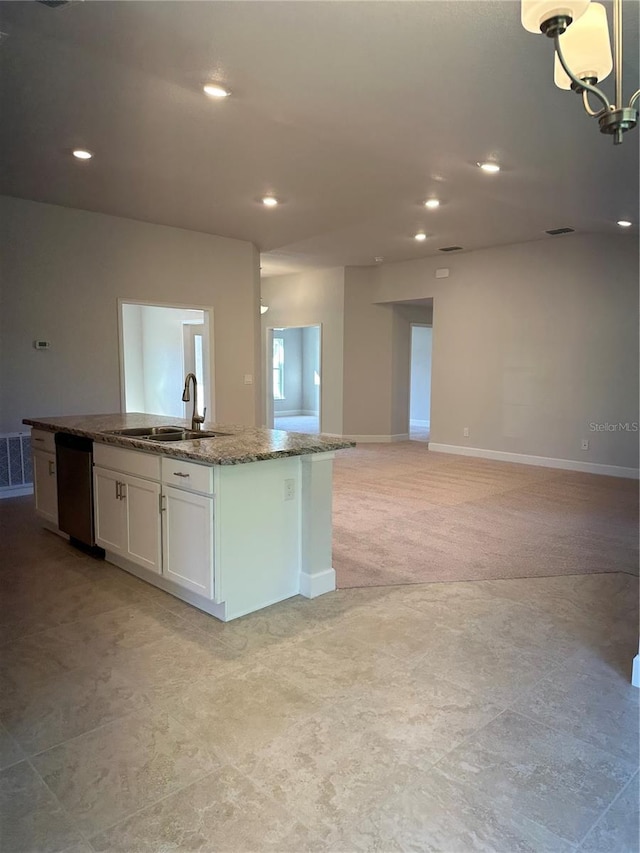 kitchen with sink, dark stone countertops, dishwasher, a kitchen island with sink, and white cabinets