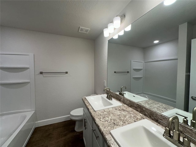 full bathroom featuring toilet, wood-type flooring, a textured ceiling, vanity, and independent shower and bath