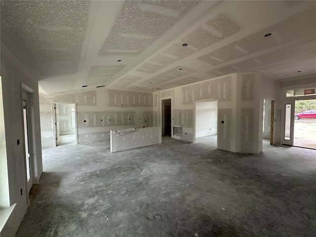 unfurnished living room featuring lofted ceiling