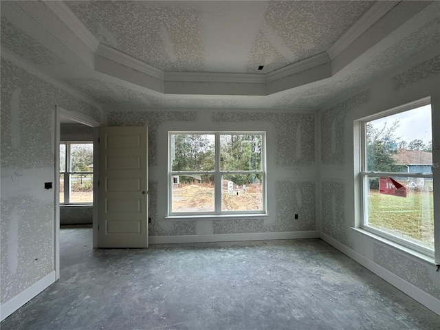 spare room featuring a raised ceiling, crown molding, and a textured ceiling