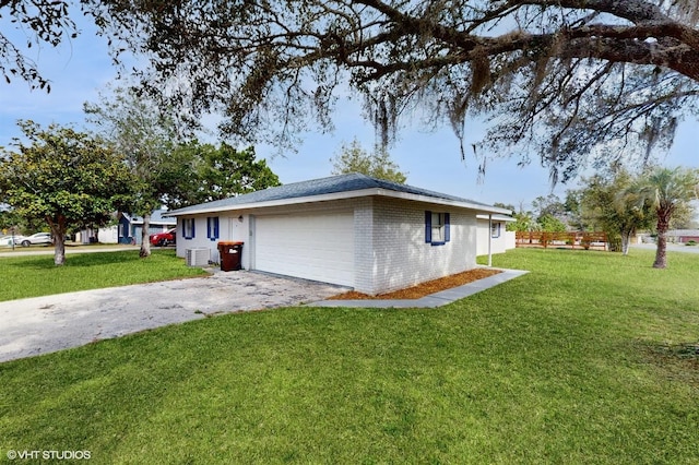 view of side of property with a yard and a garage