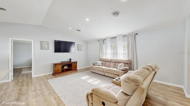 living room with vaulted ceiling and light hardwood / wood-style floors