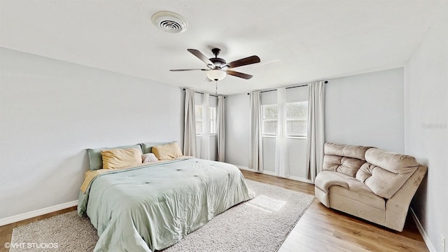 bedroom with ceiling fan and light wood-type flooring