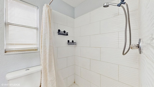 bathroom featuring toilet and a shower with curtain