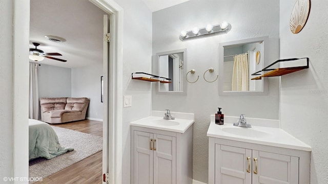 bathroom with hardwood / wood-style flooring, vanity, and ceiling fan