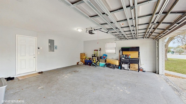 garage with a garage door opener and electric panel