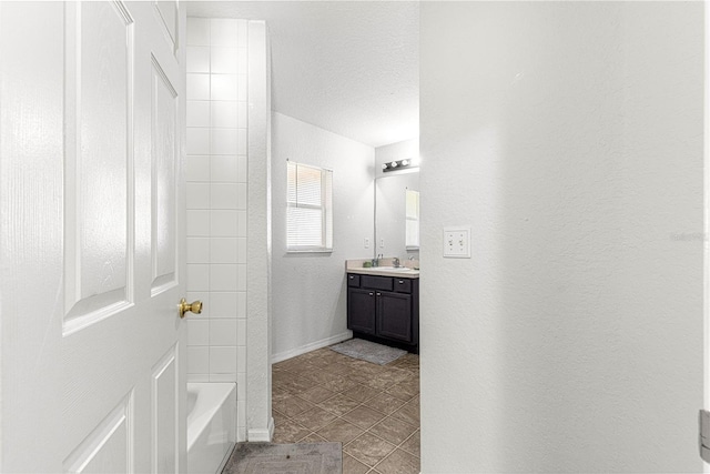 bathroom with vanity, tub / shower combination, tile patterned floors, and a textured ceiling