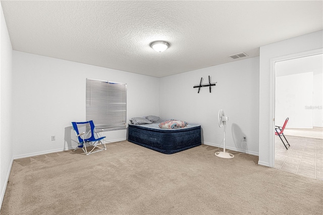 unfurnished bedroom with carpet flooring and a textured ceiling