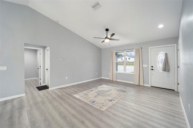 entryway with ceiling fan, light hardwood / wood-style flooring, and high vaulted ceiling