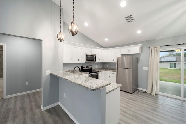 kitchen featuring light wood-type flooring, kitchen peninsula, decorative light fixtures, appliances with stainless steel finishes, and white cabinets