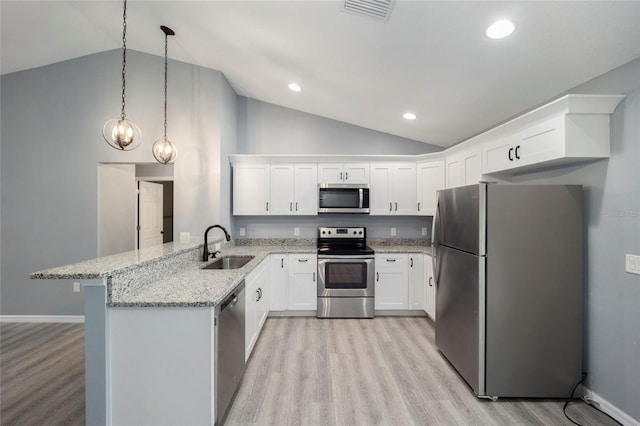 kitchen featuring white cabinetry, kitchen peninsula, appliances with stainless steel finishes, and decorative light fixtures