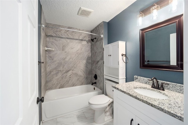 full bathroom featuring tiled shower / bath combo, toilet, vanity, and a textured ceiling