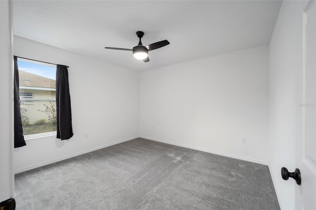 empty room with ceiling fan and carpet floors