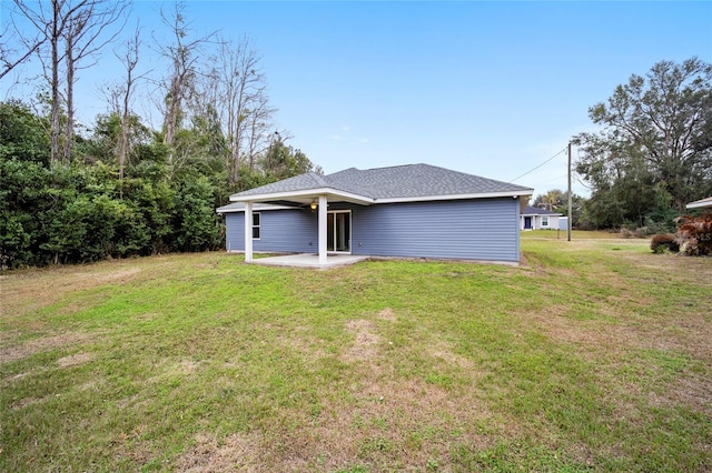 back of property with a yard and a patio