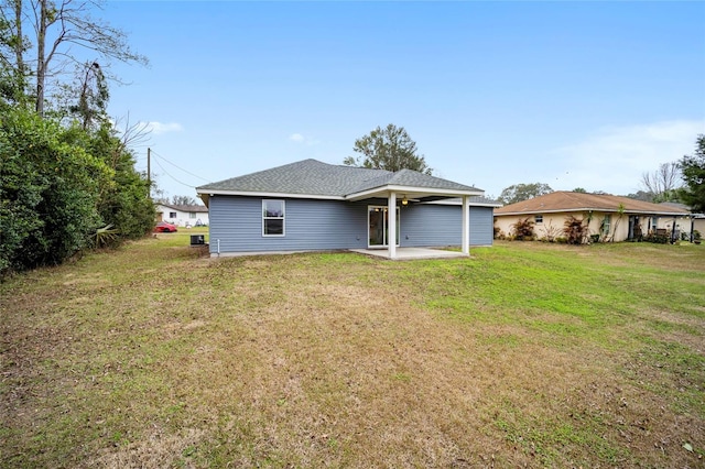 back of property with a patio area and a lawn