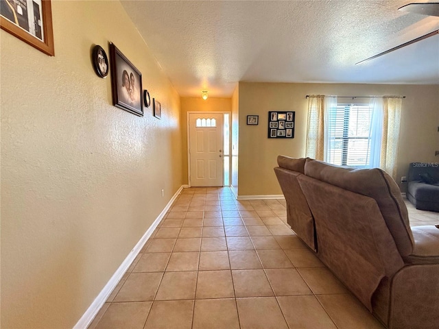 tiled foyer featuring a textured ceiling