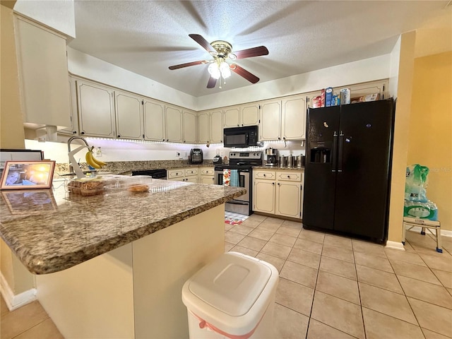 kitchen with light tile patterned floors, kitchen peninsula, ceiling fan, cream cabinets, and black appliances