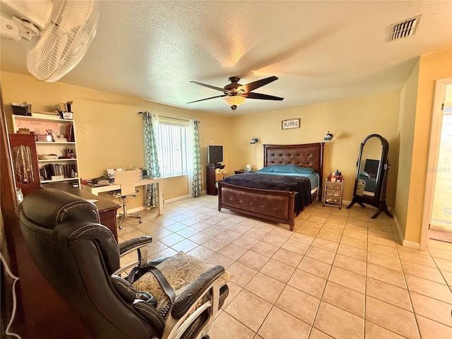 bedroom featuring light tile patterned floors, a textured ceiling, and ceiling fan