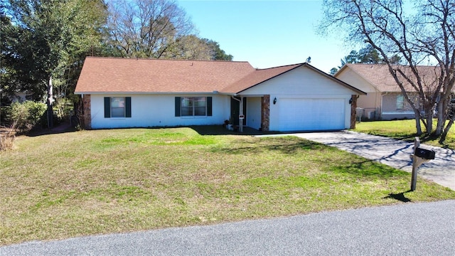 single story home featuring a garage and a front lawn