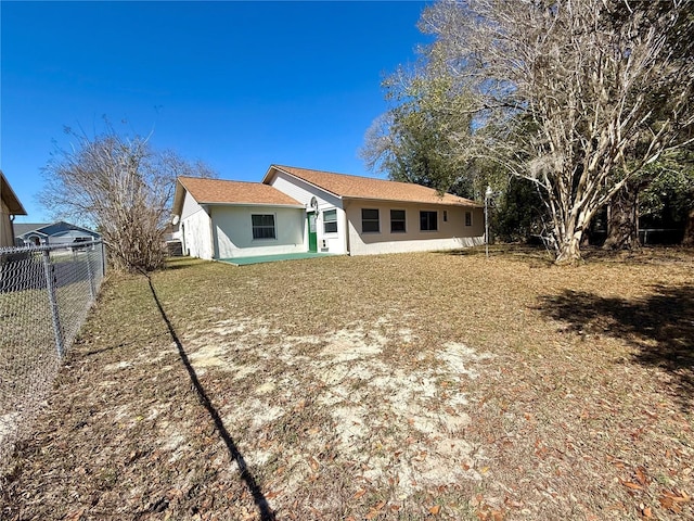 rear view of house with a lawn